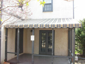 Residential patio covered in a striped canvas