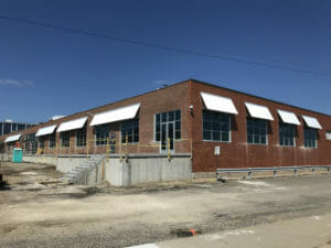 Commercial building with many custom corrugated sheet metal awnings