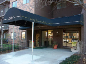Entrance canopy with posts and graphics by Acme Awning