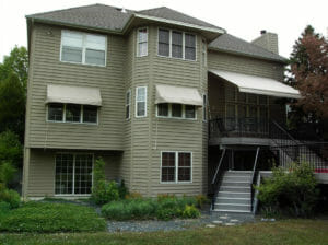 Window and deck awnings provide shade for these homeowners