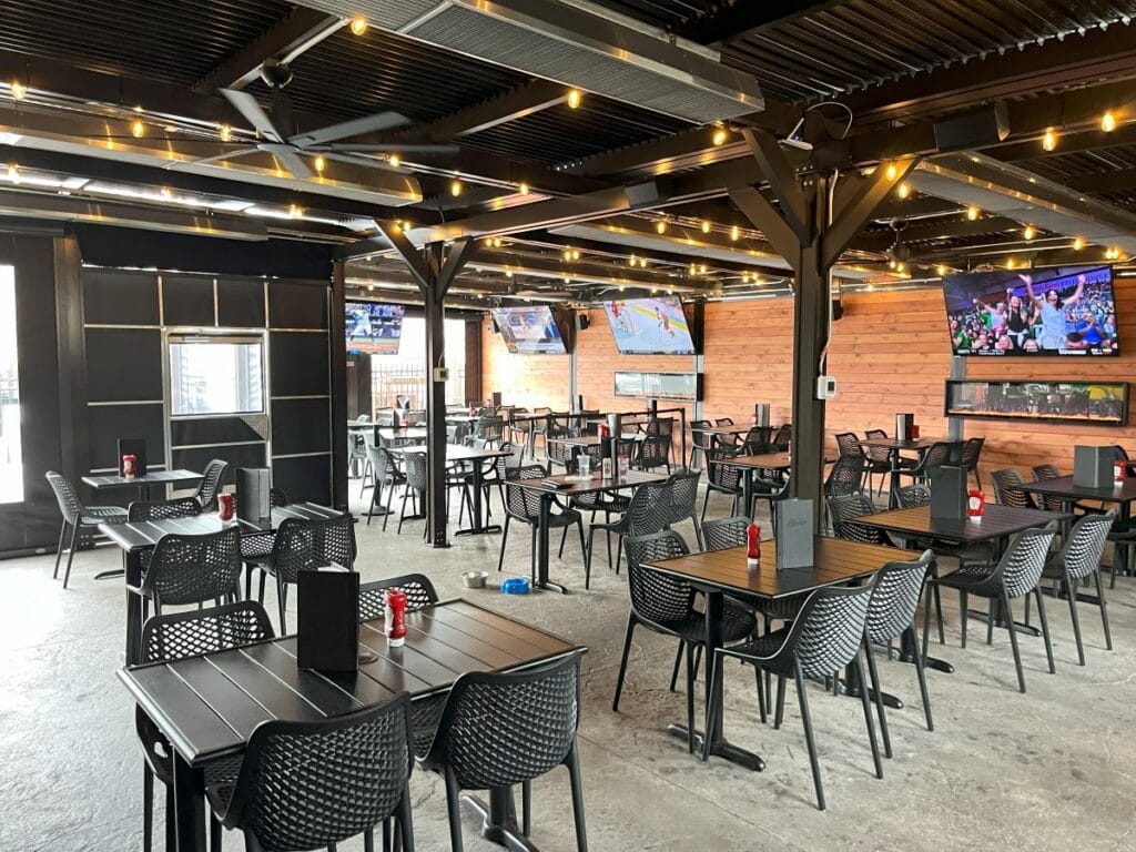 An inside view of Stanley's enclosed patio showing TVs, ceiling fans, heaters, lights and more.